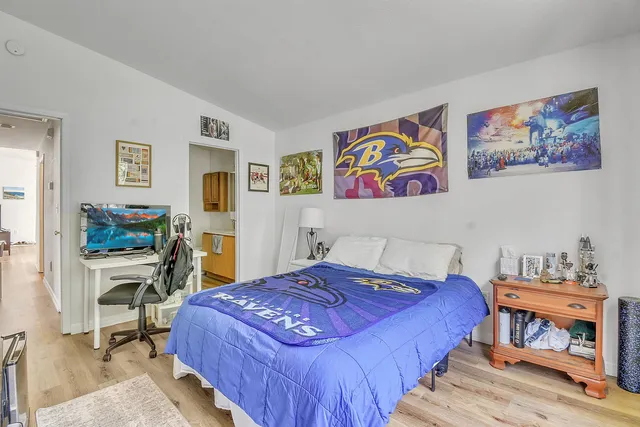 a bedroom with a bed and a workspace