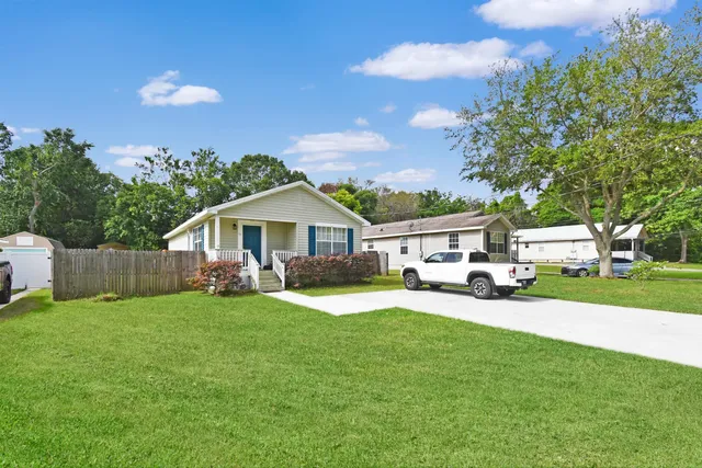 a front view of a house with a garden