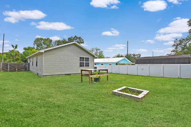 a backyard of a house with table and chairs