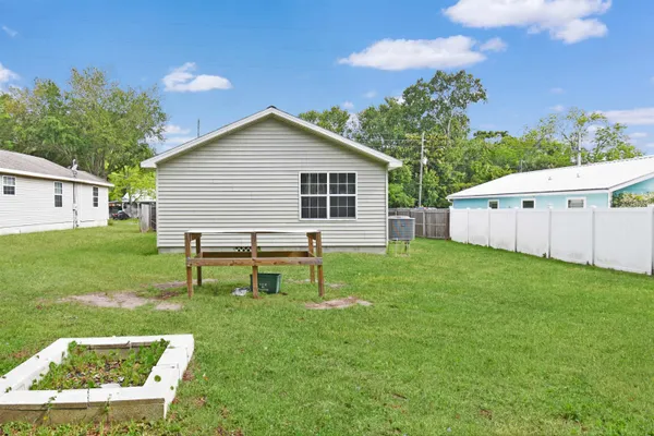 a backyard of a house with table and chairs