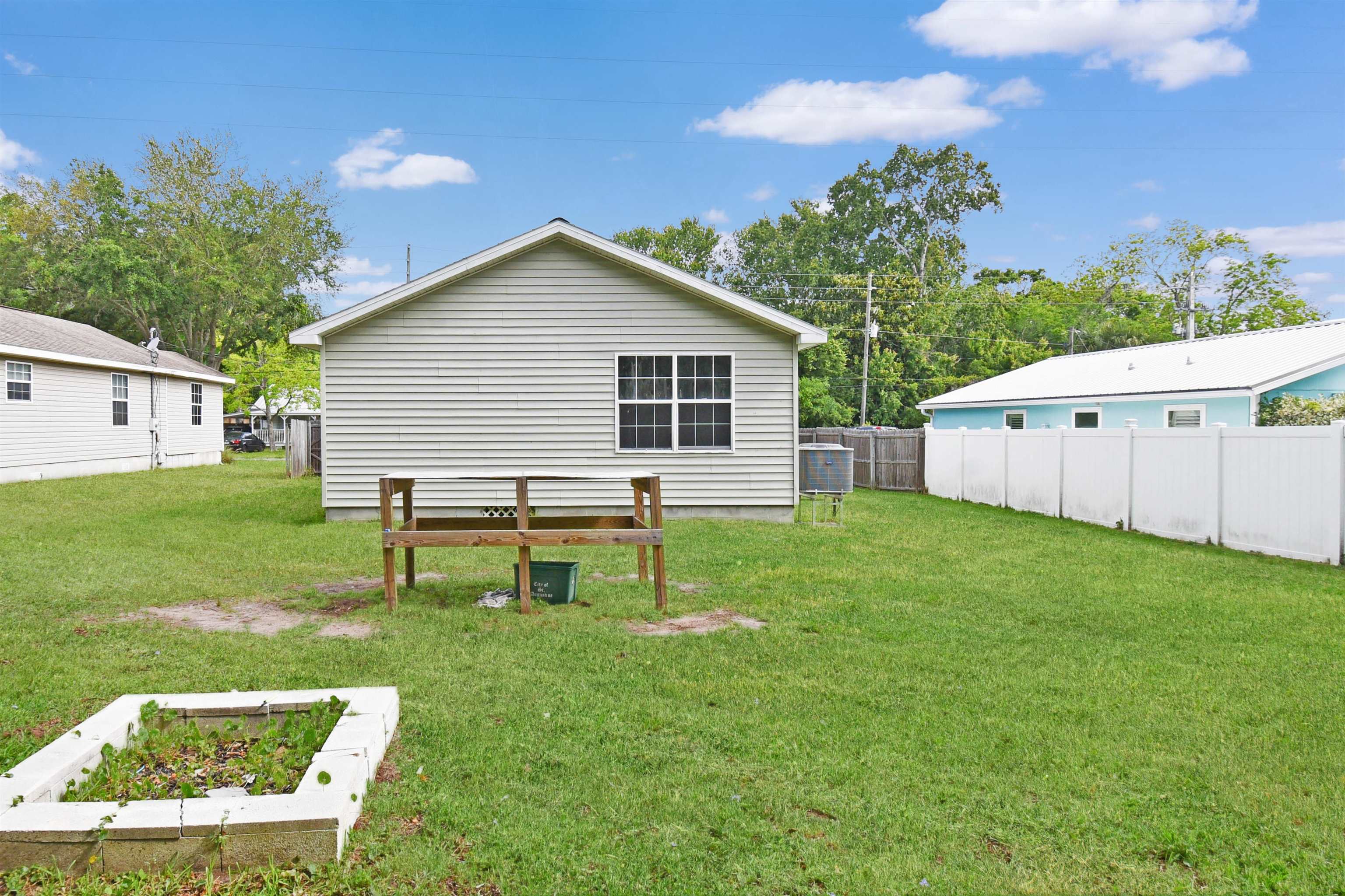 67 Anderson Street St. Augustine, FL 32084 - Photo 7 of 22 a backyard of a house with table and chairs