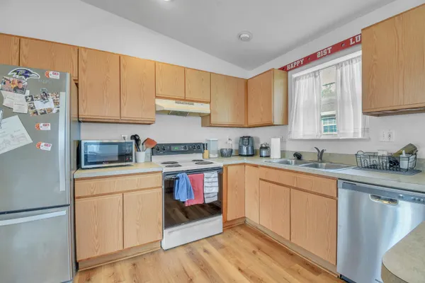 a kitchen with stainless steel appliances granite countertop a refrigerator sink and cabinets