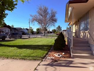 588 North 4500 West West Point, UT 84015 - Photo 58 of 61 Exterior featuring a front porch with railing, concrete steps, and a neatly manicured lawn