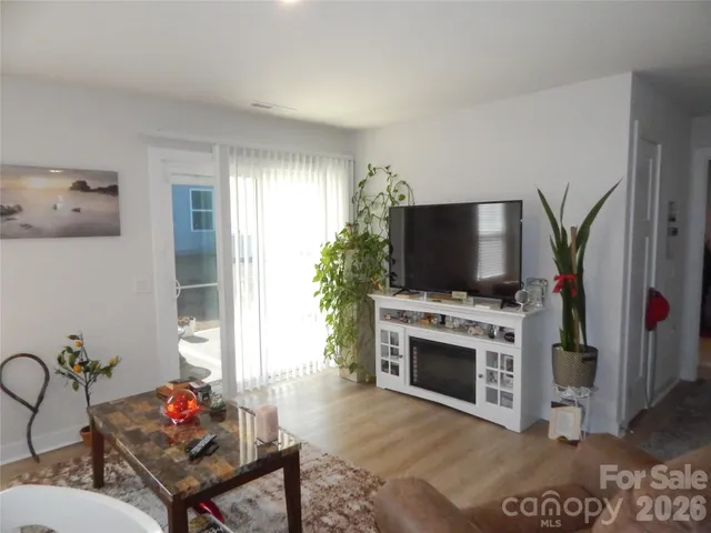 a dining room with furniture and wooden floor
