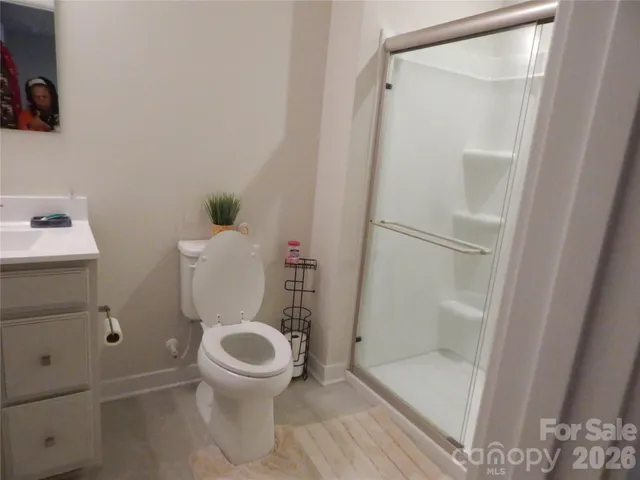 a bedroom with a bed and a potted plant