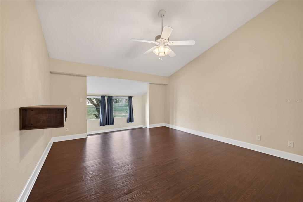 46 Nottingham Way Haines City, FL 33844 - Photo 12 of 18 a view of an empty room with wooden floor and a window