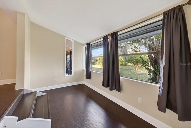 a view of a room with wooden floor and walls