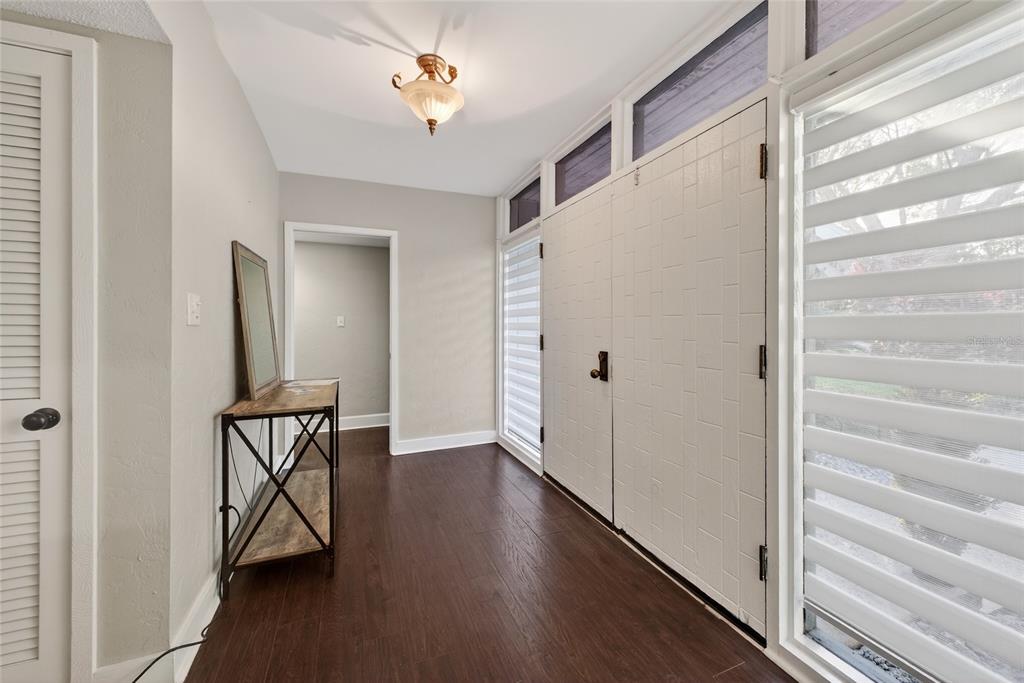 46 Nottingham Way Haines City, FL 33844 - Photo 3 of 18 a view of a hallway with wooden floor and staircase