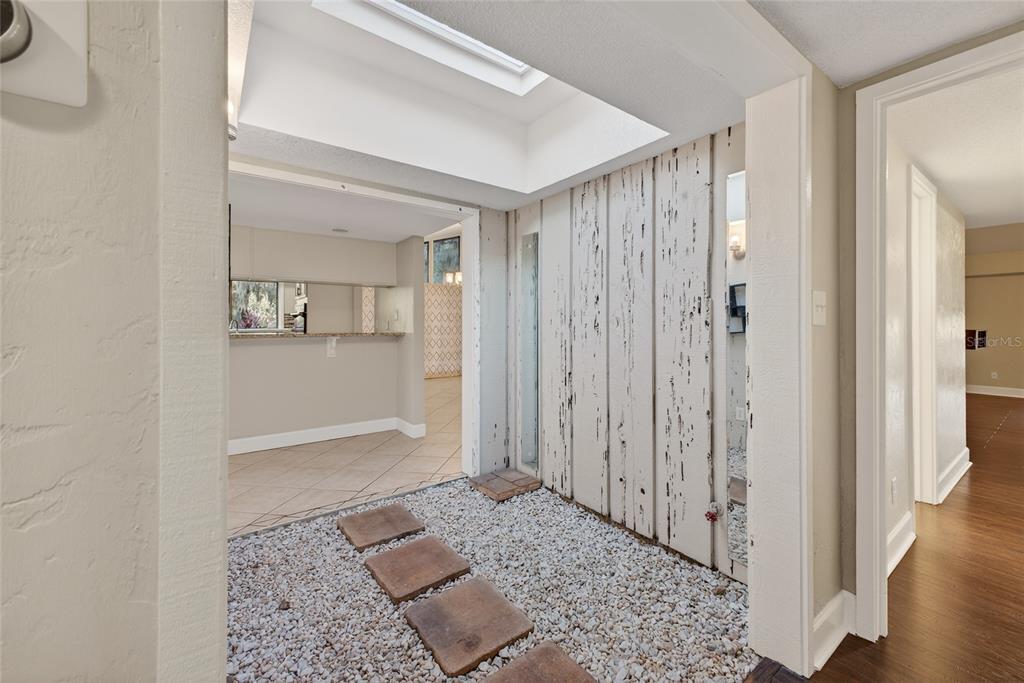 46 Nottingham Way Haines City, FL 33844 - Photo 8 of 18 a view of a hallway with wooden floor and a living room