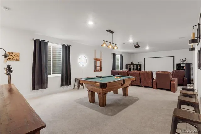 a living room with furniture a table and kitchen view