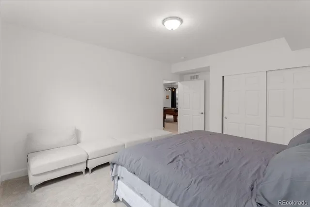 a bedroom with a bed and a couch