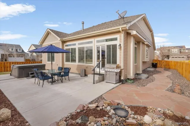 a view of a patio with a dining table and chairs with wooden floor