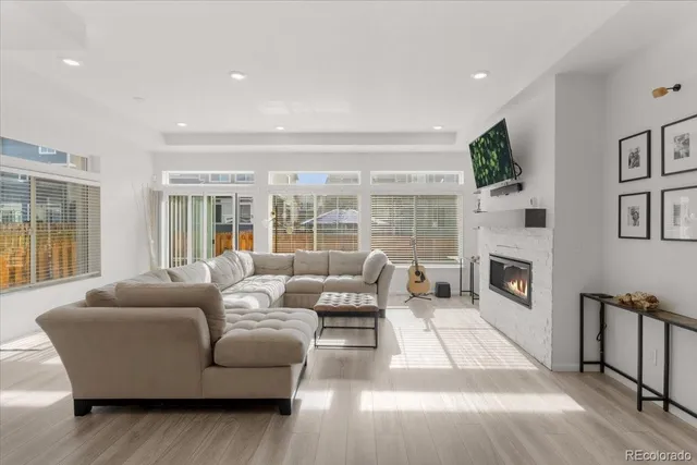 a living room with furniture large window and a flat screen tv