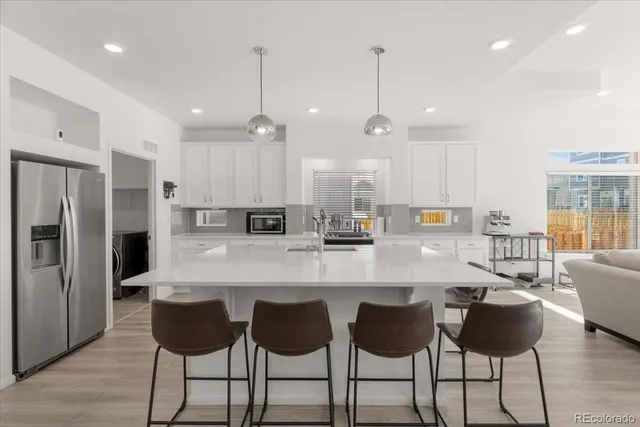 a large kitchen with a table and chairs