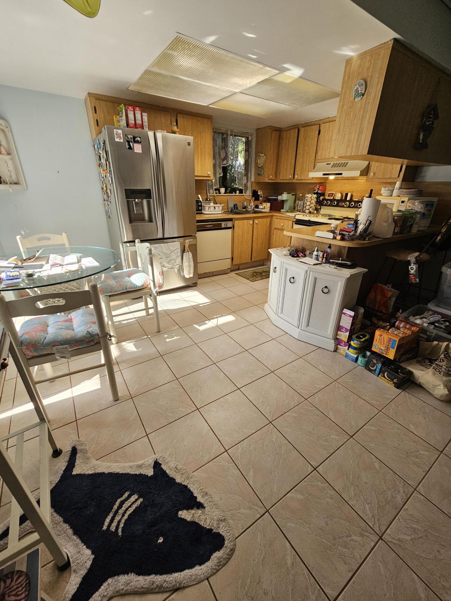 2936 Kirk Road Lake Worth, FL 33461 - Photo 14 of 23 a kitchen with stainless steel appliances kitchen island granite countertop a sink and cabinets