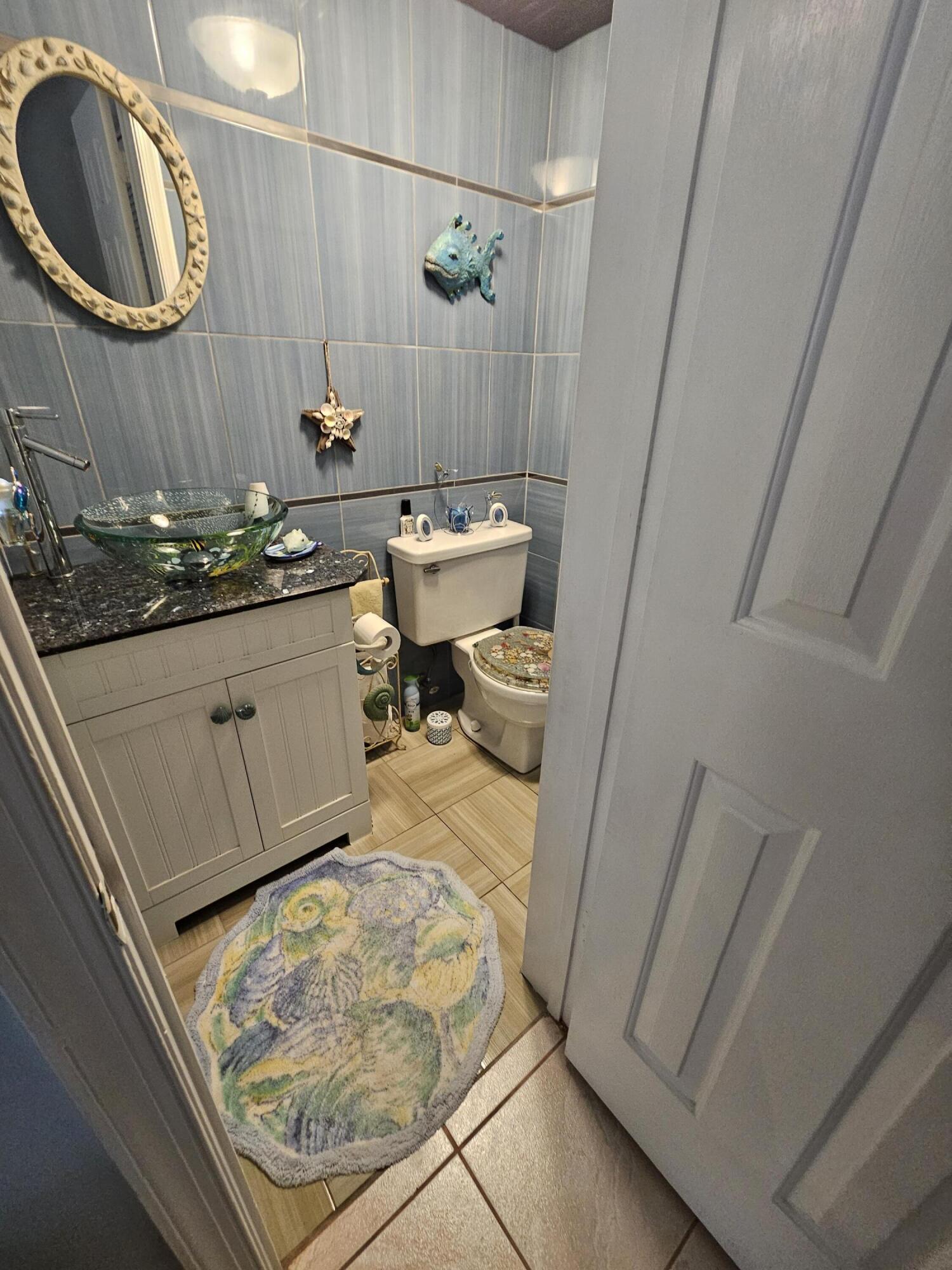 2936 Kirk Road Lake Worth, FL 33461 - Photo 15 of 23 a bathroom with a sink and a mirror