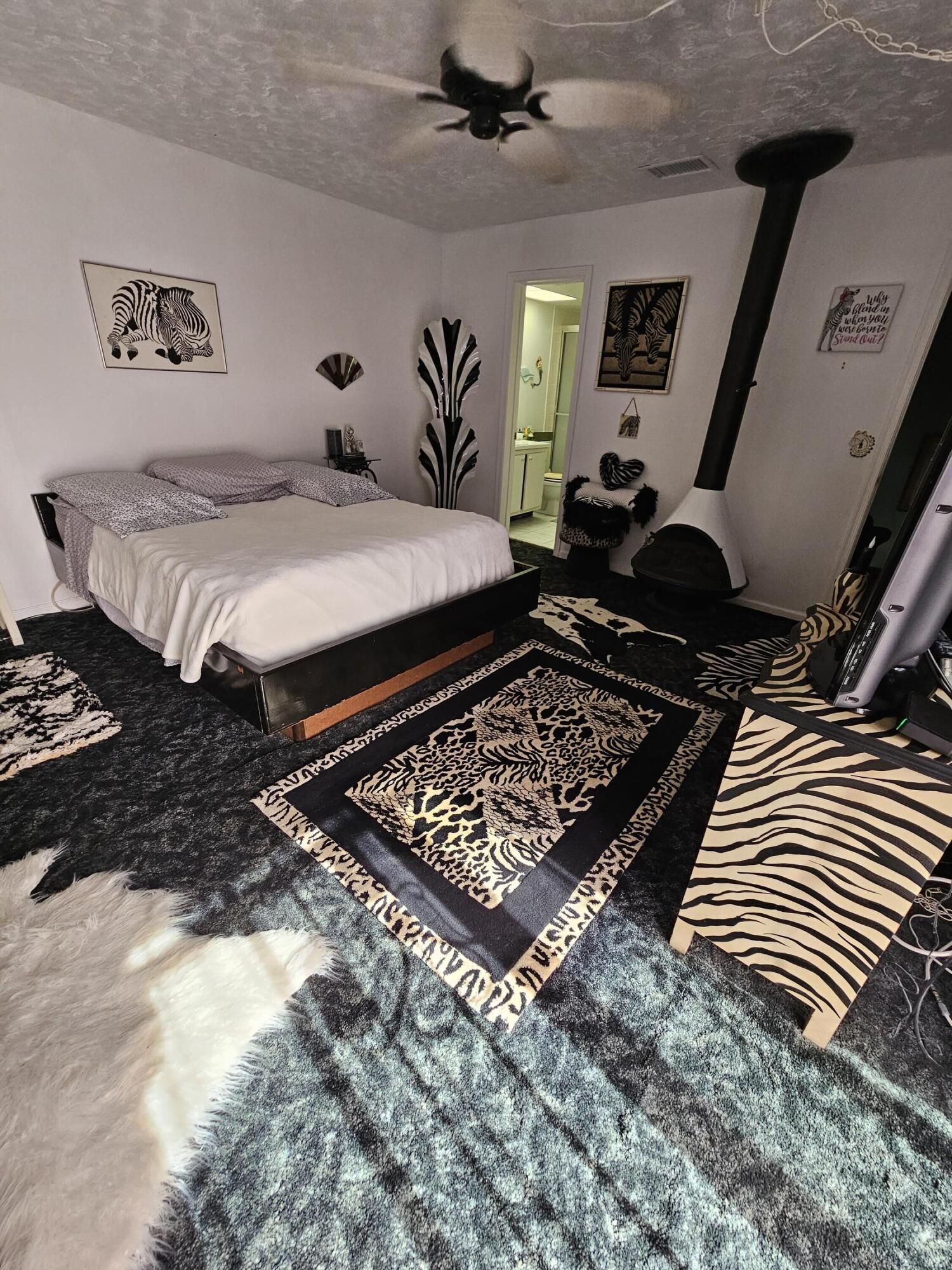 2936 Kirk Road Lake Worth, FL 33461 - Photo 17 of 23 a bedroom with a bed and a rug