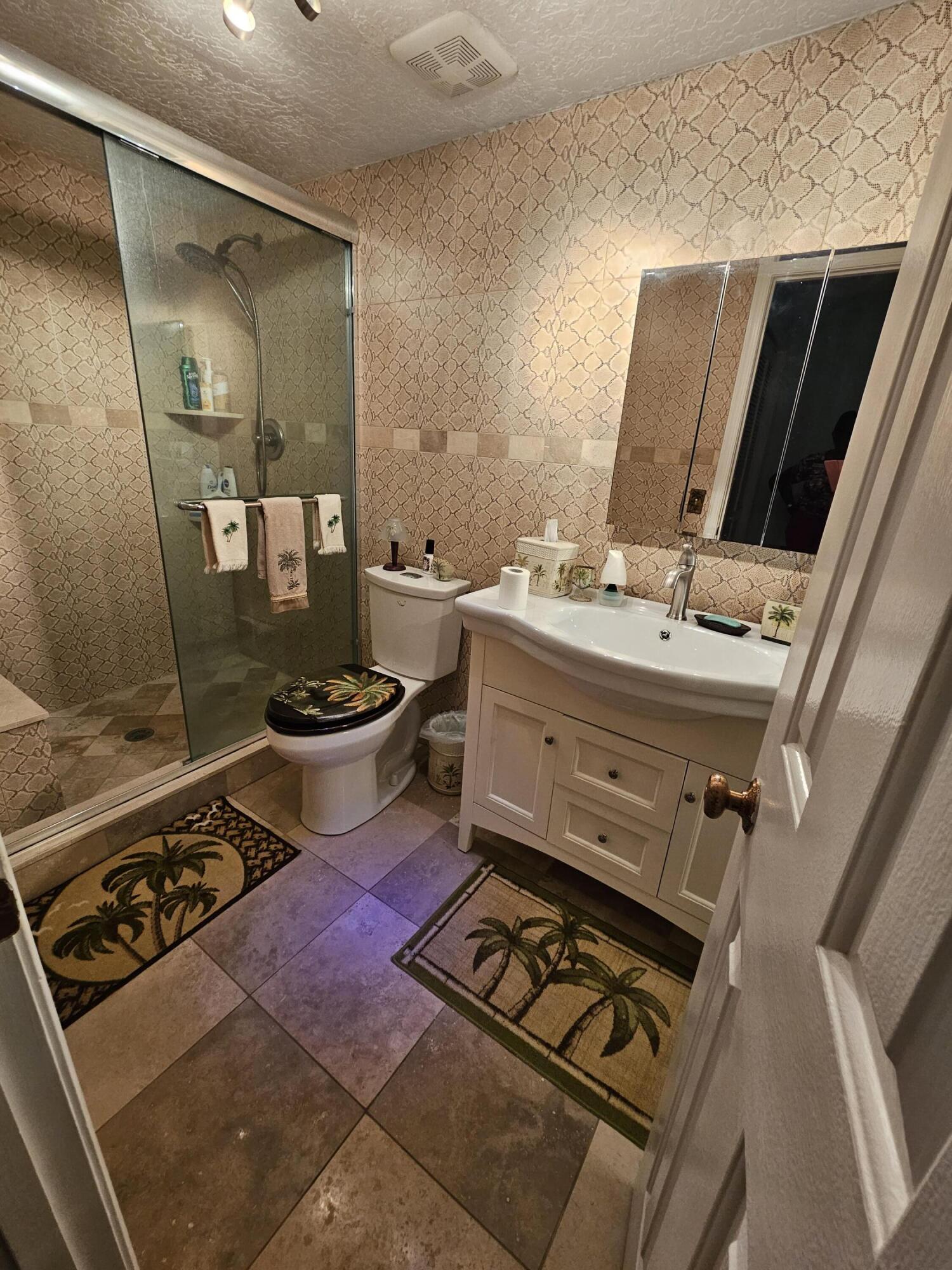 2936 Kirk Road Lake Worth, FL 33461 - Photo 20 of 23 a bathroom with a toilet a sink and mirror