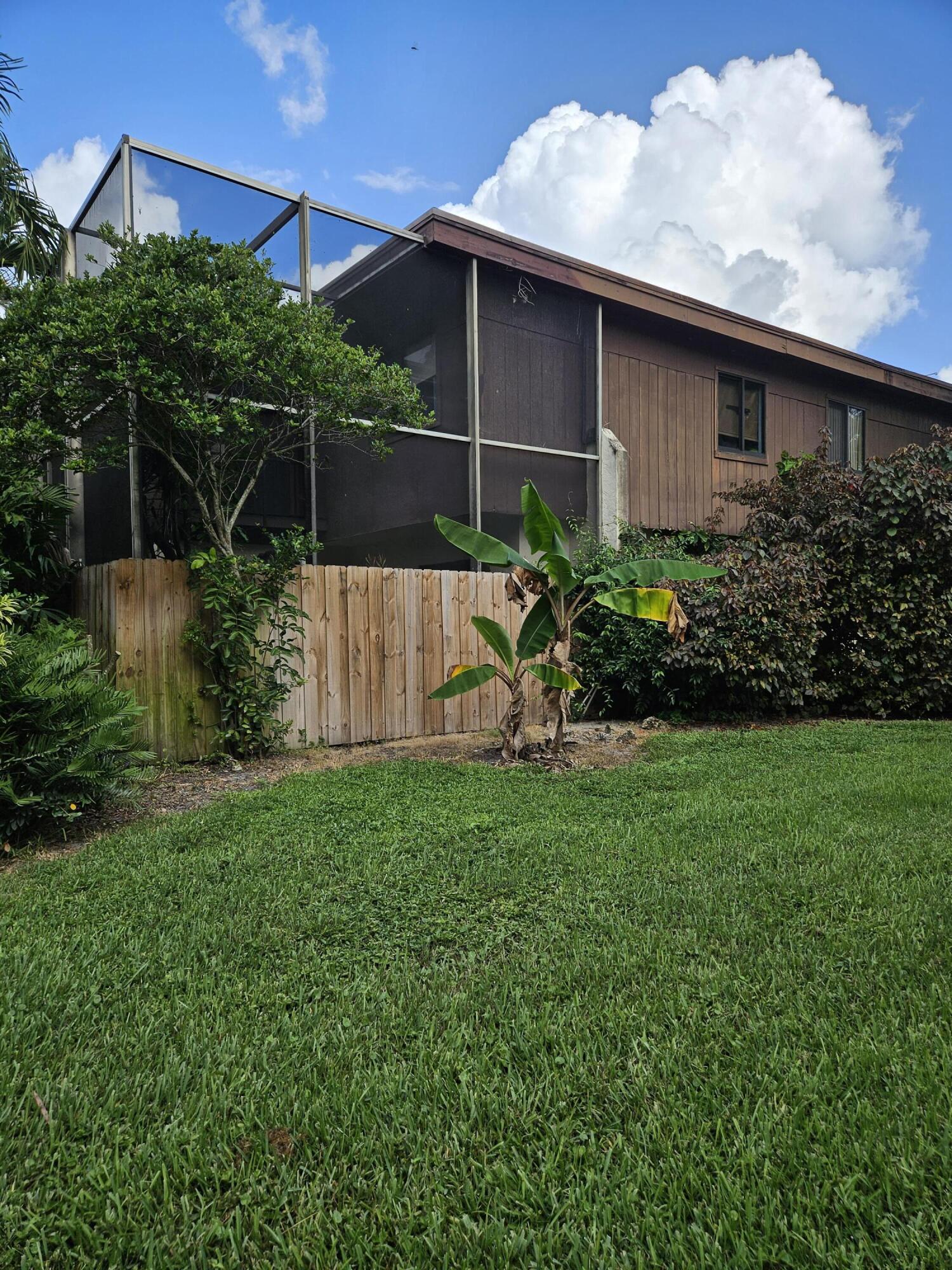 2936 Kirk Road Lake Worth, FL 33461 - Photo 2 of 23 a backyard of a house with lots of green space