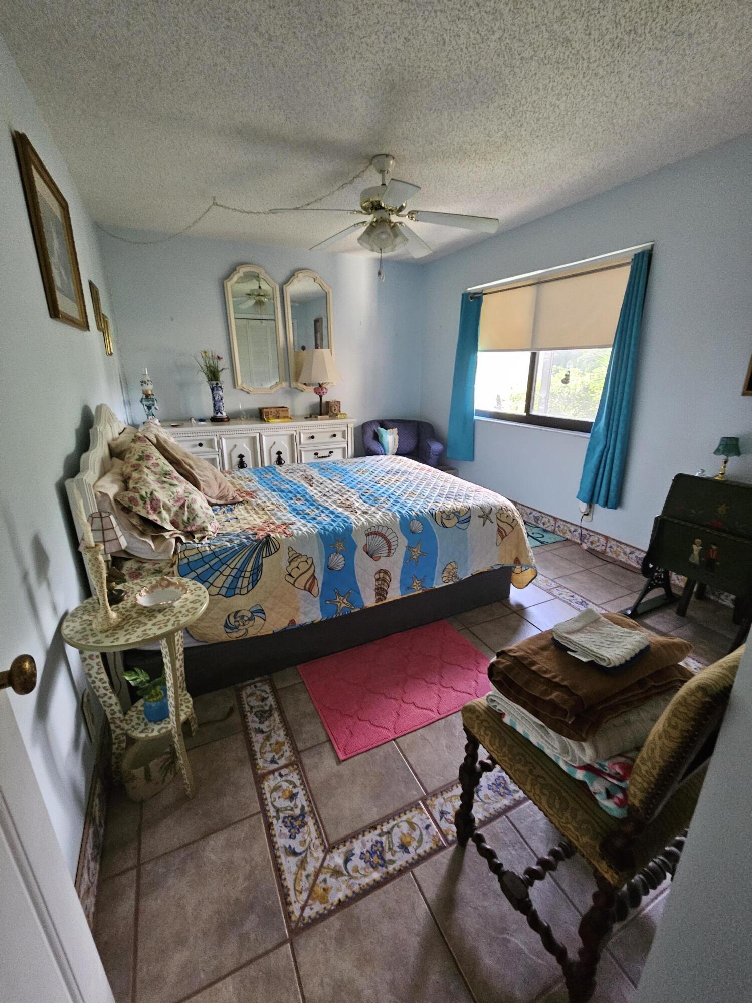2936 Kirk Road Lake Worth, FL 33461 - Photo 21 of 23 a bedroom with furniture and a window