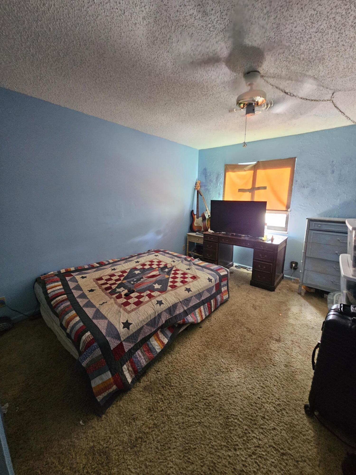 2936 Kirk Road Lake Worth, FL 33461 - Photo 22 of 23 a bedroom with a bed and window