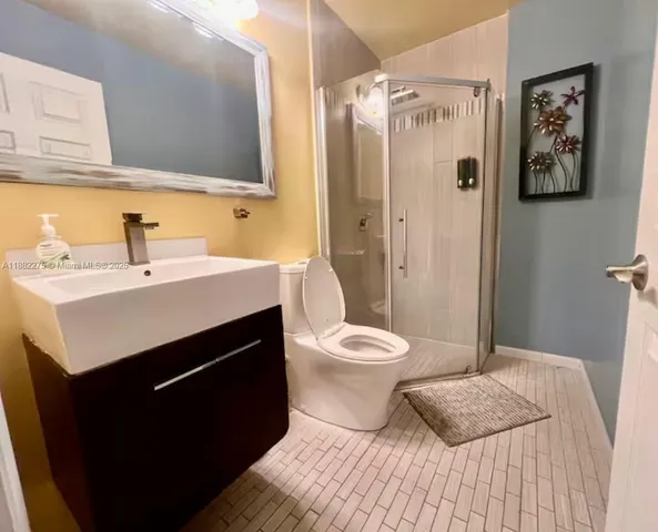 a white toilet sitting next to a white wall