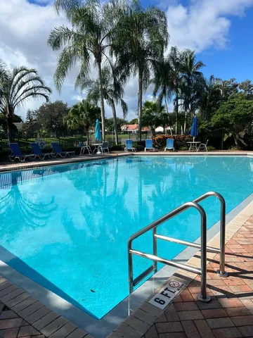 a view of a lake with a big yard and large trees