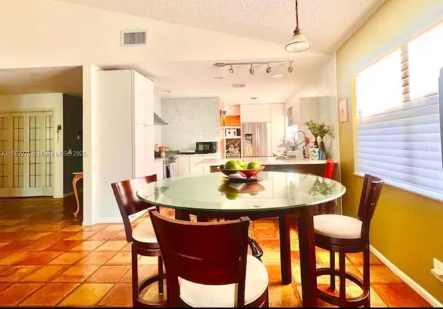 a view of a dining room with furniture and a table