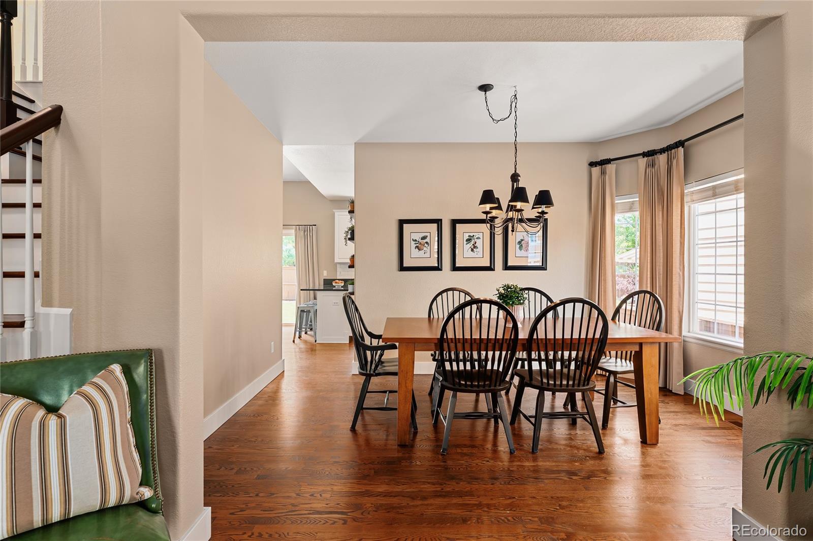 9441 South Hackberry Lane Highlands Ranch, CO 80129 - Photo 12 of 50 a view of a dining room with furniture window and wooden floor