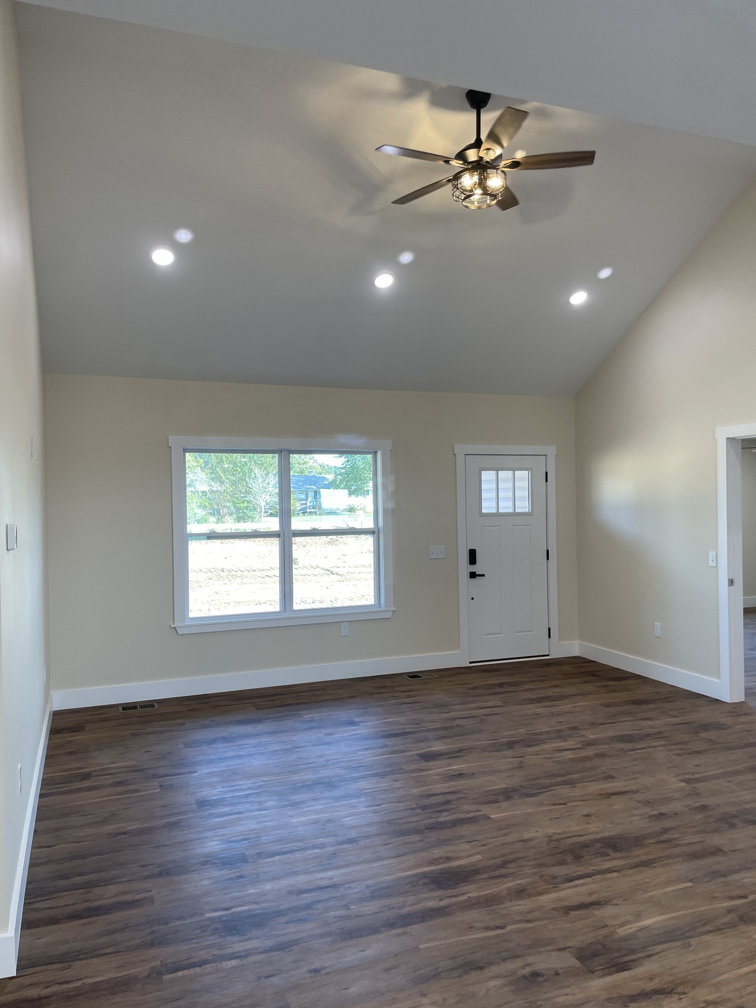 181 Rigling Road Loretto, TN 38469 - Photo 5 of 36 a view of an empty room with a window and wooden floor