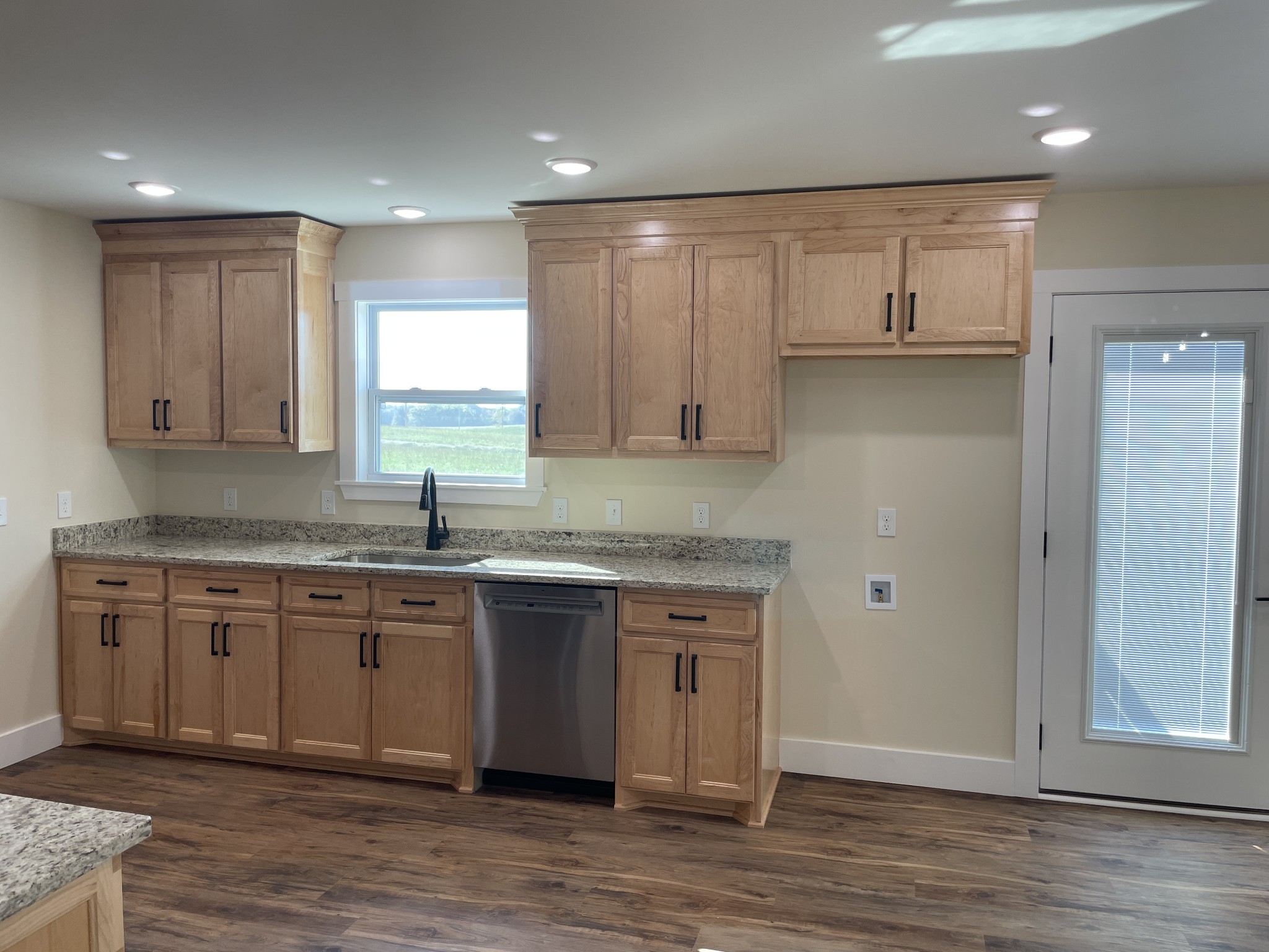 181 Rigling Road Loretto, TN 38469 - Photo 8 of 36 a kitchen with stainless steel appliances granite countertop a stove a sink and a microwave