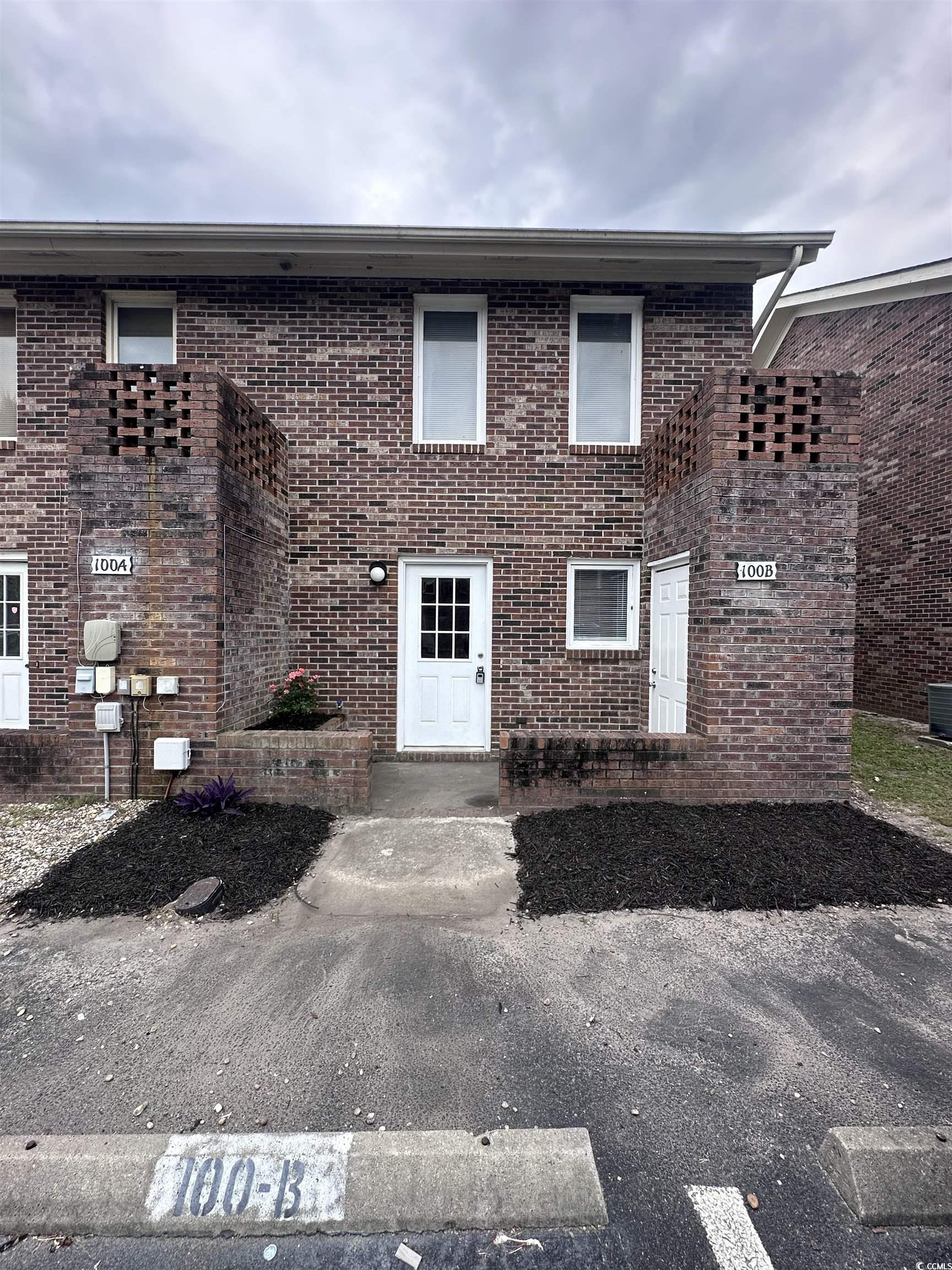 View of front facade featuring brick siding