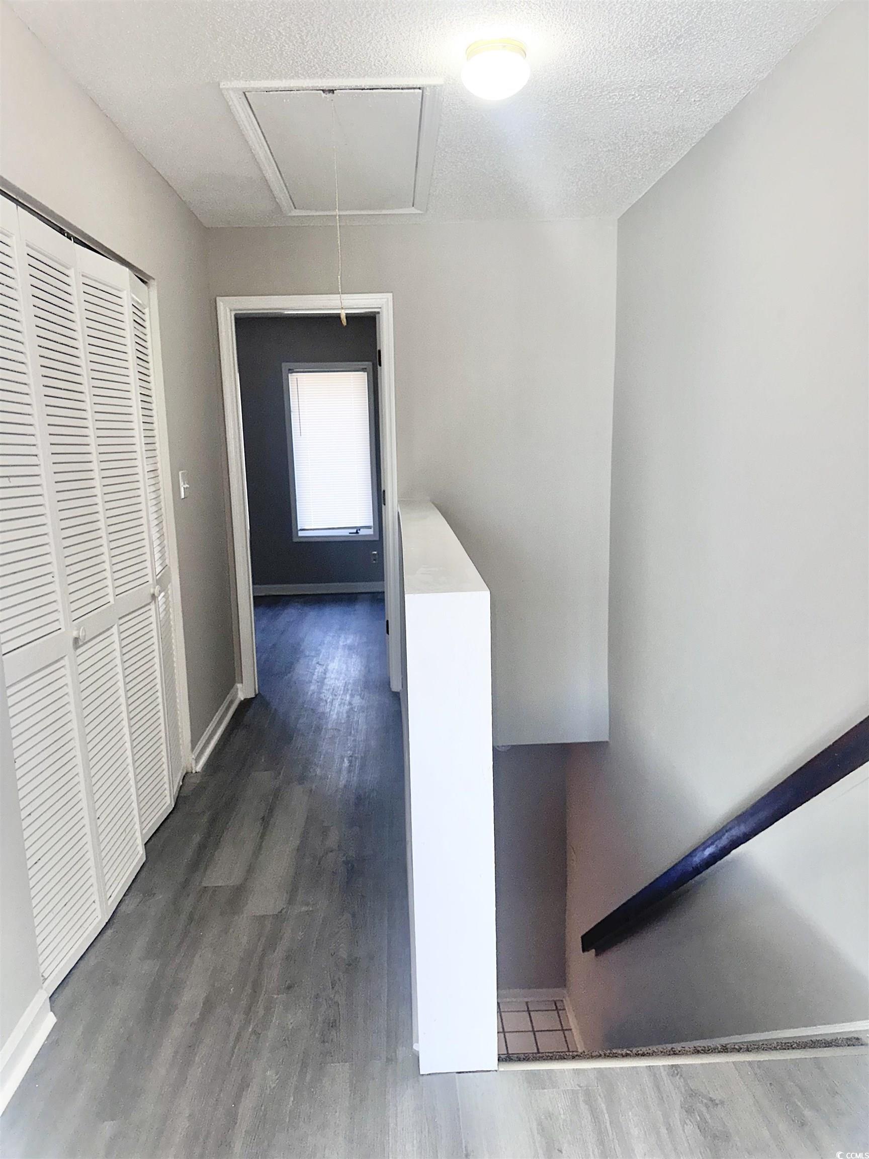 401 Garden Drive, Unit 100B Myrtle Beach, SC 29575 - Photo 16 of 23 Corridor featuring attic access and dark wood finished floors