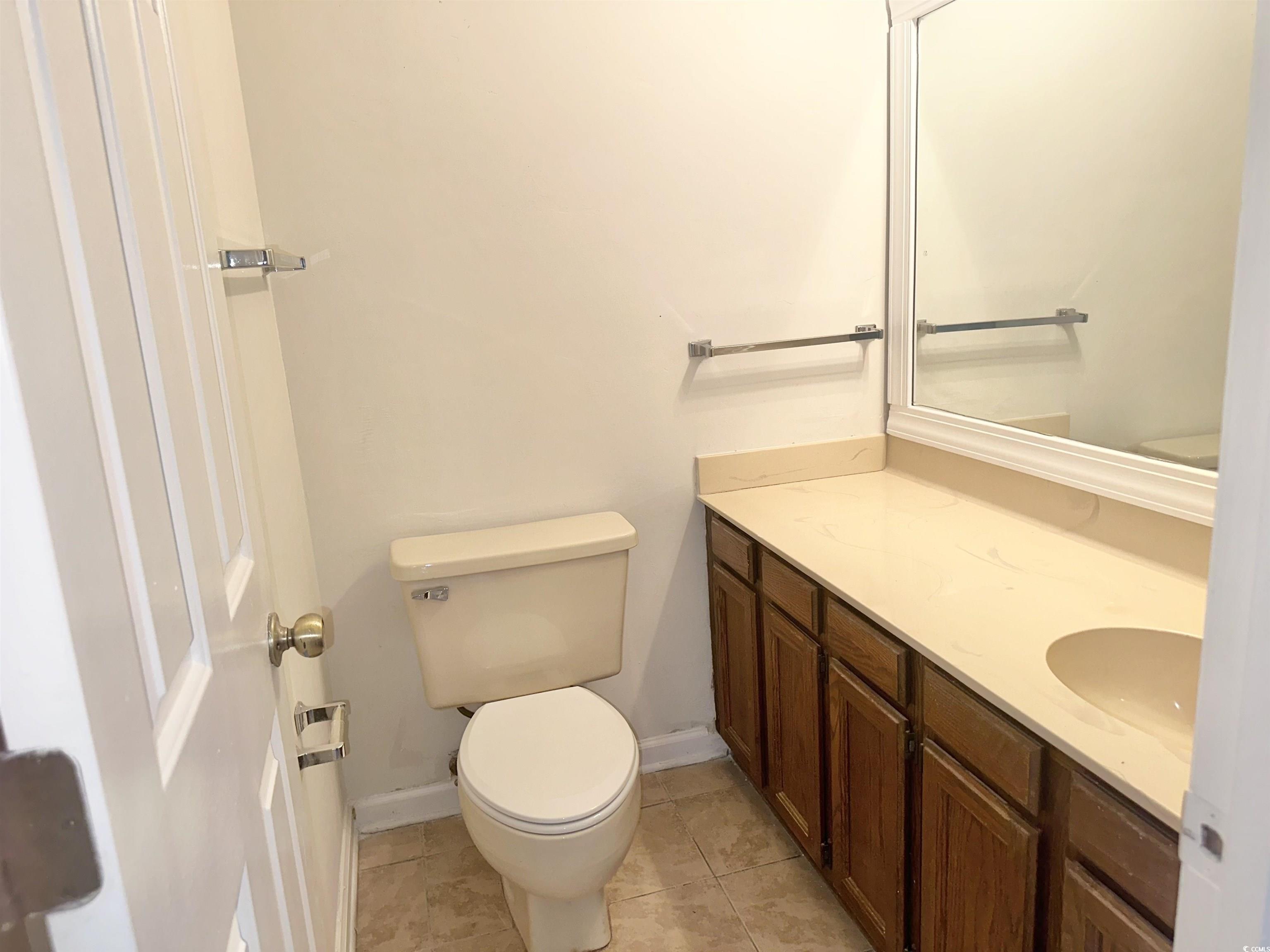 401 Garden Drive, Unit 100B Myrtle Beach, SC 29575 - Photo 20 of 23 Bathroom featuring vanity and tile patterned flooring