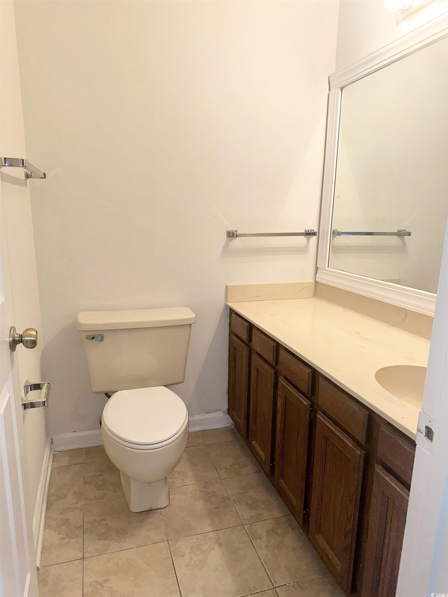 401 Garden Drive, Unit 100B Myrtle Beach, SC 29575 - Photo 21 of 23 Bathroom featuring vanity and tile patterned floors