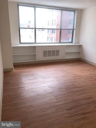 a view of wooden floor and windows in a room