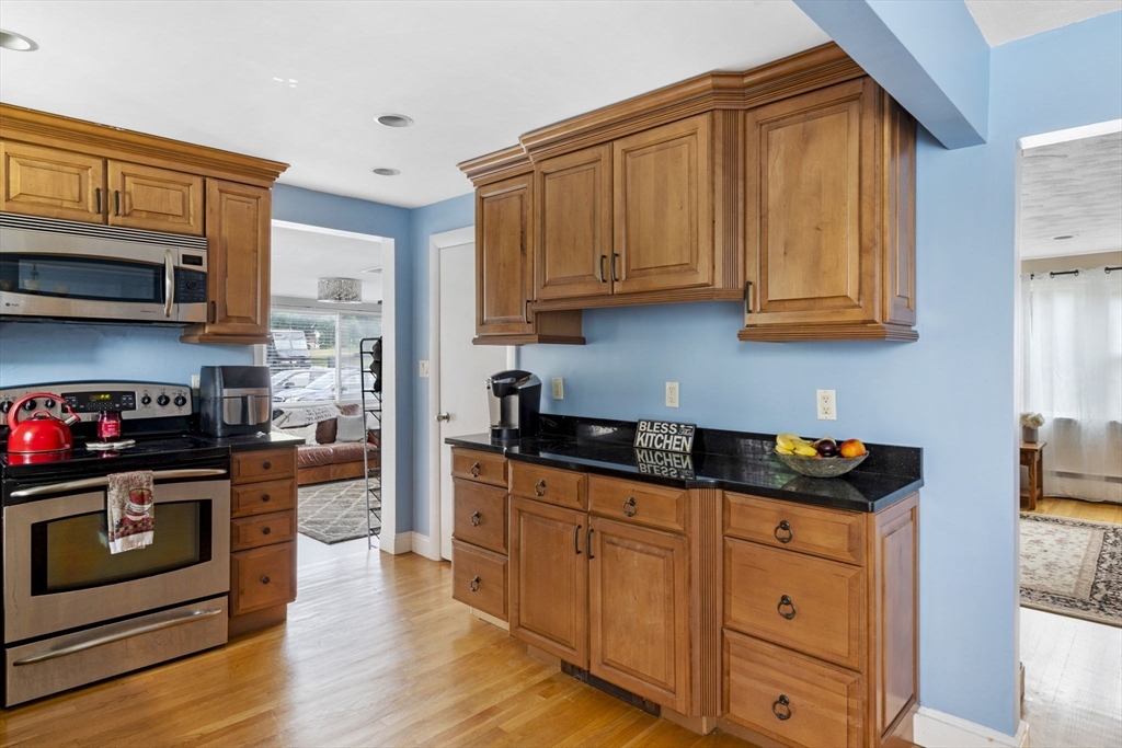 27 Raylen Avenue Peabody, MA 01960 - Photo 11 of 42 a kitchen with stainless steel appliances granite countertop a stove a sink and a microwave