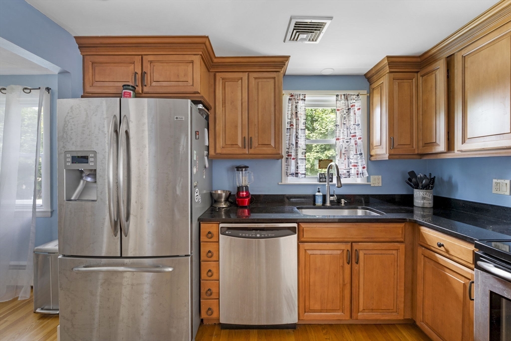 27 Raylen Avenue Peabody, MA 01960 - Photo 13 of 42 a kitchen with granite countertop stainless steel appliances a refrigerator a sink and cabinets