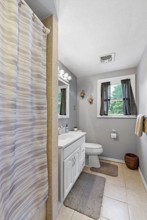 27 Raylen Avenue Peabody, MA 01960 - Photo 17 of 42 a bathroom with a toilet a sink and mirror