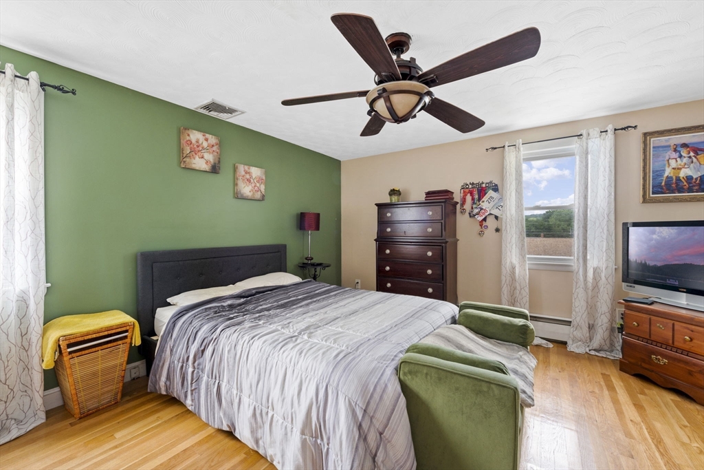 27 Raylen Avenue Peabody, MA 01960 - Photo 21 of 42 a bedroom with a bed and a television