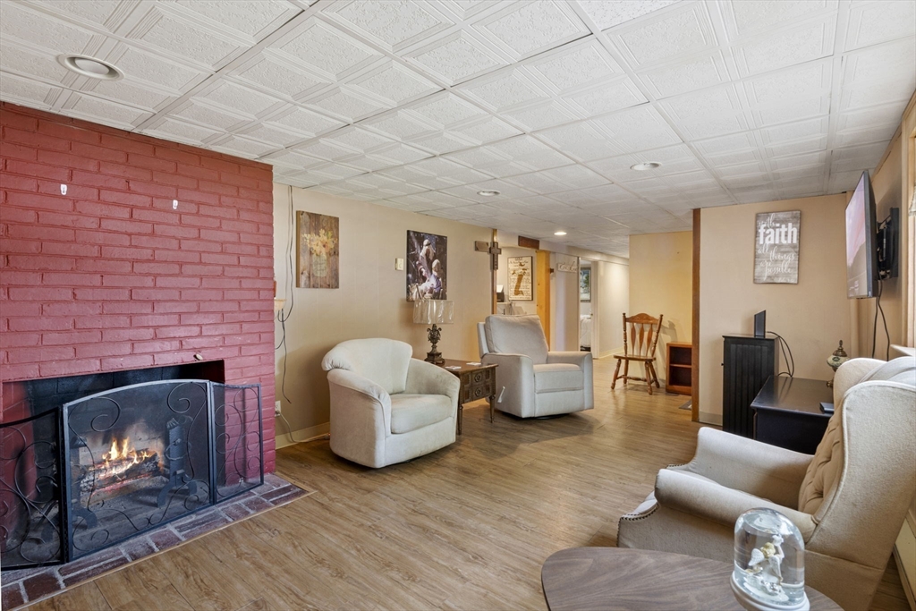 27 Raylen Avenue Peabody, MA 01960 - Photo 26 of 42 a living room with furniture and a fireplace