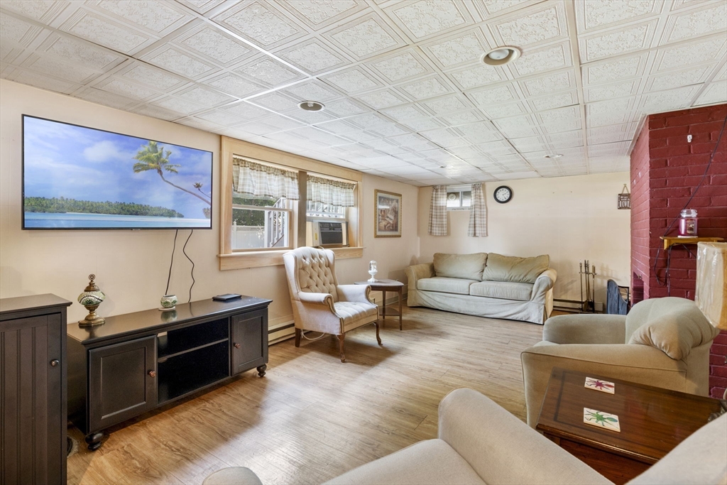27 Raylen Avenue Peabody, MA 01960 - Photo 28 of 42 a living room with furniture a flat screen tv and a window