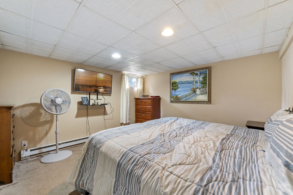 27 Raylen Avenue Peabody, MA 01960 - Photo 33 of 42 a bedroom with a bed and a large mirror