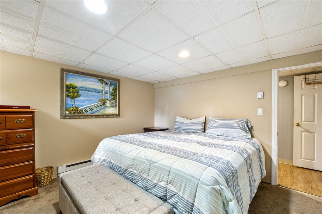 27 Raylen Avenue Peabody, MA 01960 - Photo 34 of 42 a bedroom with a bed and a painting on the wall