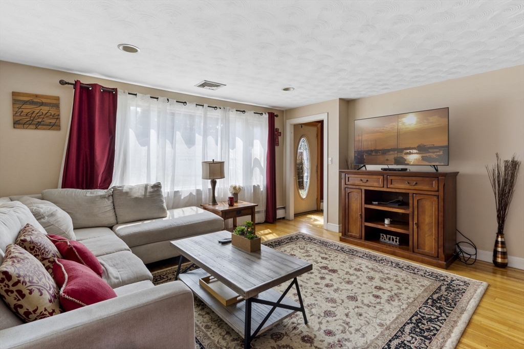 27 Raylen Avenue Peabody, MA 01960 - Photo 7 of 42 a living room with furniture and a flat screen tv
