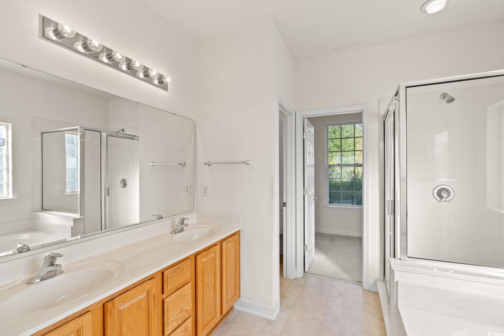 875 Brookline Drive Myrtle Beach, SC 29579 - Photo 15 of 40 Full bathroom featuring a shower stall, double vanity, a bath, and light tile patterned flooring