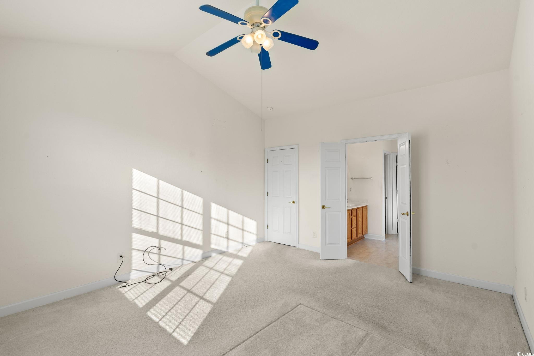 875 Brookline Drive Myrtle Beach, SC 29579 - Photo 20 of 40 Unfurnished bedroom with light carpet, lofted ceiling, connected bathroom, and a ceiling fan