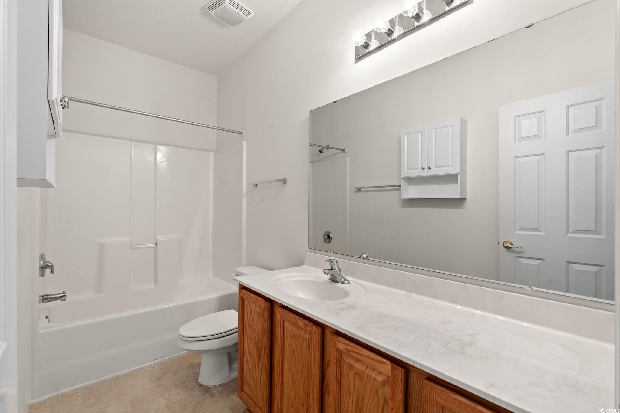 875 Brookline Drive Myrtle Beach, SC 29579 - Photo 21 of 40 Full bathroom with shower / bath combination, vanity, and light tile patterned floors