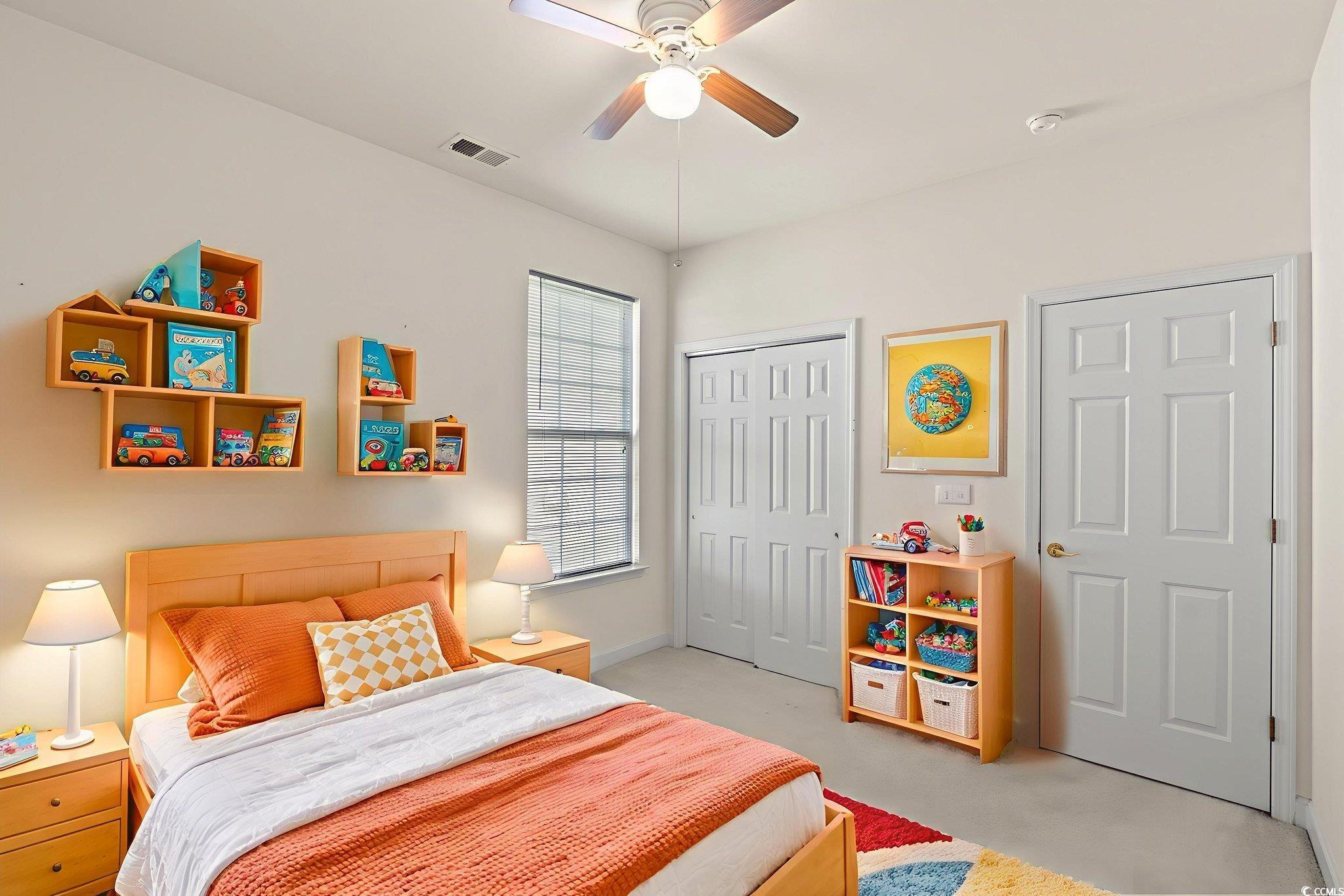 875 Brookline Drive Myrtle Beach, SC 29579 - Photo 22 of 40 Bedroom with light colored carpet, a ceiling fan, and a closet