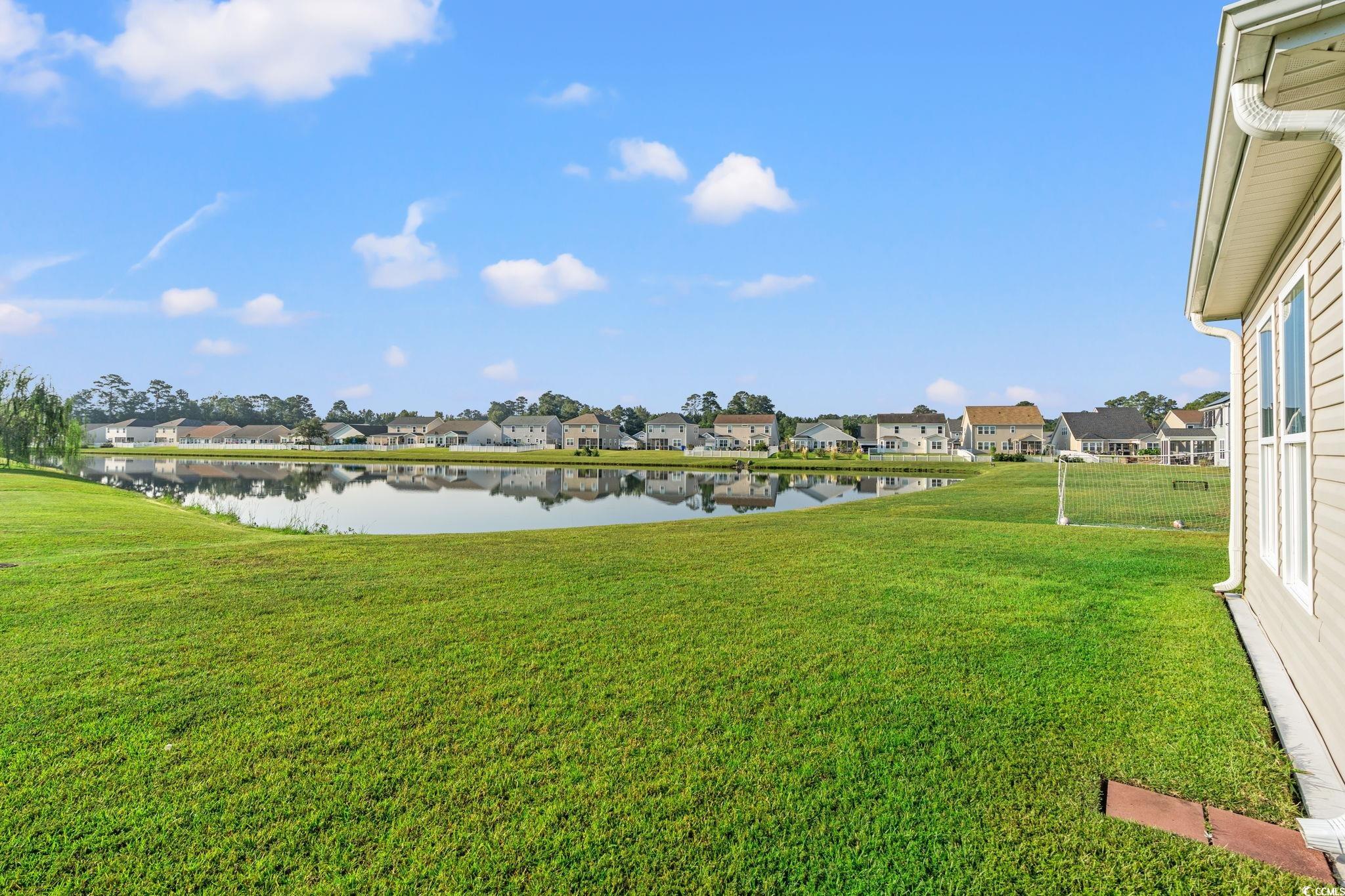 875 Brookline Drive Myrtle Beach, SC 29579 - Photo 26 of 40 View of green lawn featuring a water view and a residential view